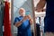 Joyful grey haired man admiring his reflection in shopping store