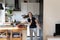 Joyful happy dancer girl enjoying cooking in kitchen,