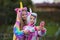 Joyful happy girlfriends in uniform unicorn costume selfie on the phone