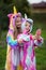 Joyful happy girlfriends in uniform unicorn costume selfie on the phone