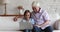 Joyful happy senior grandfather and gen Z grandkid using laptop