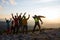 Joyful hikers, friends with open arms are standing on a top