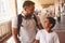 Joyful hindu boy and his father standing at the railway station