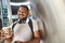 Joyful hindu male traveler drinking coffee in the airport