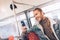 Joyful hipster man messaging by phone in bus