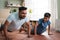 Joyful indian father with son doing push ups exercise at home - concept of Joyful fitness, Active lifestyle and healthy