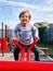 Joyful Innocence: A Beaming Young Boy on the Seesaw of Play