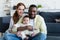 joyful interracial couple with infant child