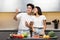 Joyful Japanese Couple Making Selfie Cooking Food Standing In Kitchen