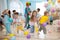 Joyful kids and clown play with color balloon on birthday party