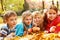 Joyful kids lying on autumnal leaves