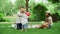 Joyful kids playing with balls in park. Three kids having fun in summer park