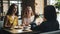 Joyful ladies taking photos with food in cafe touching smartphone screen