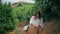 Joyful lady working harvest green citrus plantation. Farmer collecting oranges