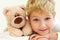 Joyful little boy with teddy bear is happy and smiling. Close-Up