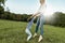 Joyful little girl playing with her mother on green grass. Loving beautiful woman and her daughter spending time together and