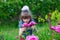 Joyful little girl sniff flowers