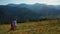 Joyful lovers in mountains drone view against amazing woods pikes background