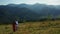 Joyful lovers in mountains drone view against amazing woods pikes background
