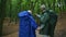 Joyful loving aged couple standing in the forest