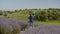 Joyful man catching butterflies with net in field