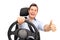 Joyful man driving and giving a thumb up