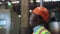 Joyful man engineer smiling at huge modern factory wearing safety uniform.