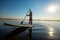 Joyful man paddling on a SUP board