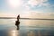 Joyful man paddling on a SUP board