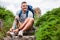 Joyful man with prosthesis tying his shoelace