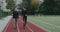 Joyful man with prosthetic running blade chatting with positive woman. Male athlete with amputed leg and happy female