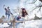 Joyful man throwing snowball at woman