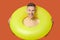 Joyful man wearing inflatable ring on shoulders