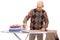 Joyful mature man ironing