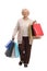 Joyful mature woman with shopping bags walking towards the camera