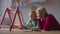 Joyful mother admiring painting of little girl