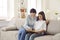 Joyful mother and her teenage daughter spend time together flipping through interesting book.