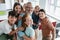 joyful multiethnic classmates looking at camera