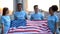 Joyful multiethnic volunteers holding American flag, charity project, support