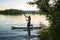 Joyful multiracial guy paddling on a SUP board