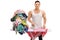 Joyful muscular guy ironing a pile of clothes