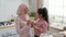 Joyful Muslim Mother And Daughter Having Fun Singing In Kitchen