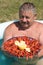 Joyful mustachioed man sits in the pool.