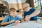 Joyful nice grandfather and grandson checking the time