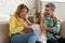 Joyful Parents And Daughter Having Fun Laughing Sitting At Home