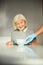 Joyful pensioner having her breakfast served by a volunteer