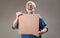 Joyful pensioner holding photo frame