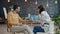 Joyful people girl and guy talking in office discussing business using laptop at table