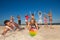 Joyful people playing volleyball