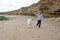 Joyful playtime with a child and a white poodle on a sandy beach